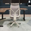 Rear view of cloud white Vari Align office chair with Alloy Grey mesh backrest and adjustable armrests, positioned in front of a desk with dual monitors.